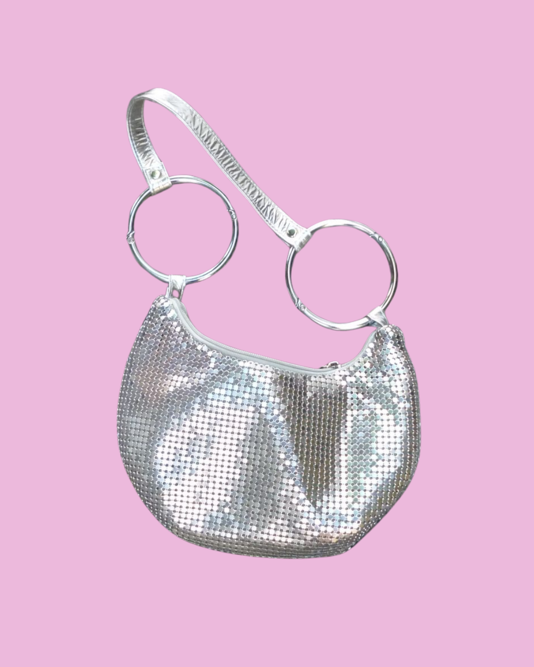 Silver metallic shoulder bag with a curved body and two oversized circular strap rings