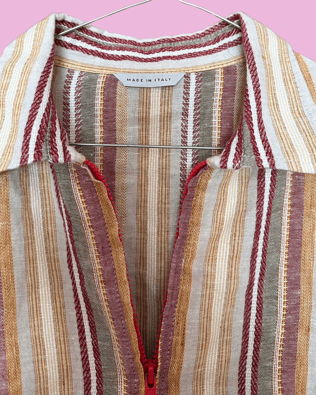 Close-up of the striped top's collar, textured weave and burgundy front zip